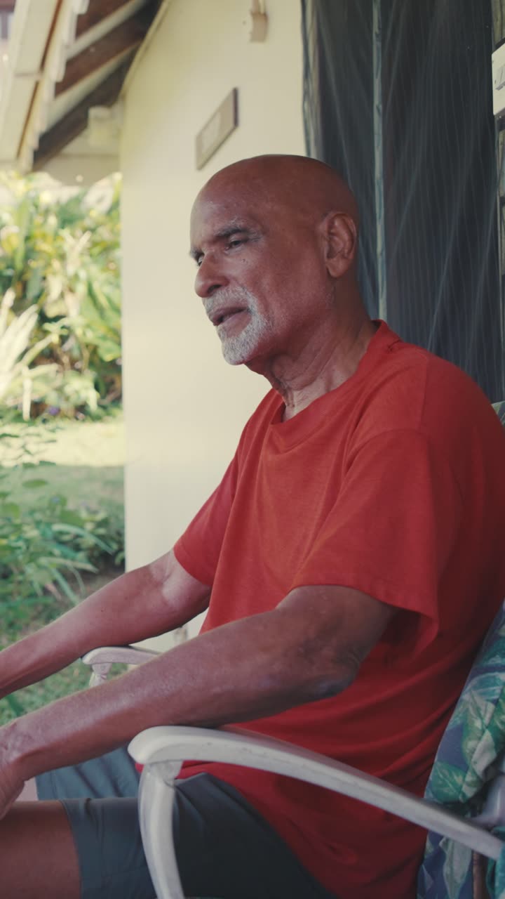 Athie Martin speaking on a porch